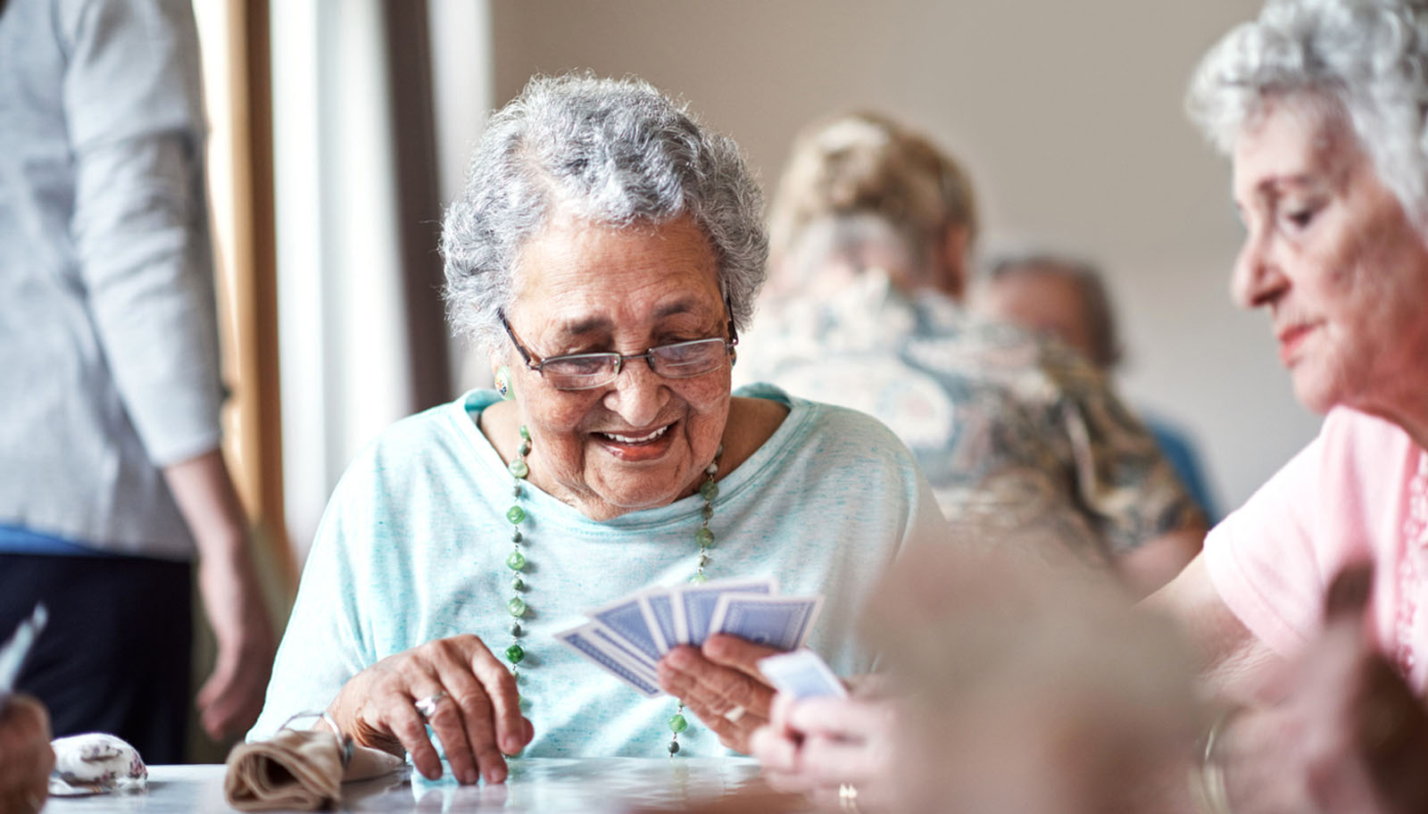 two elderly women playing cards